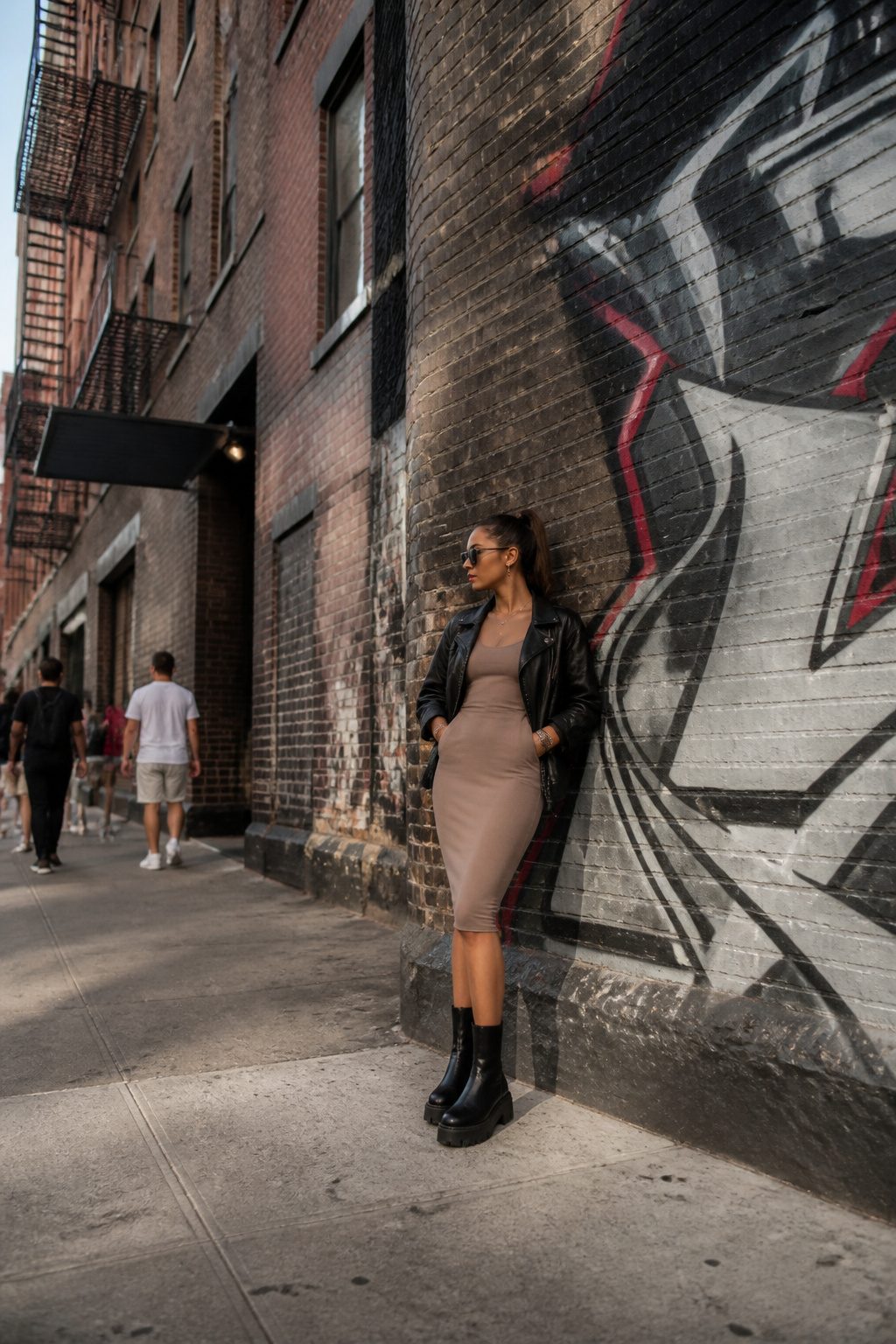 Bodycon dress paired with a leather jacket and accessories.