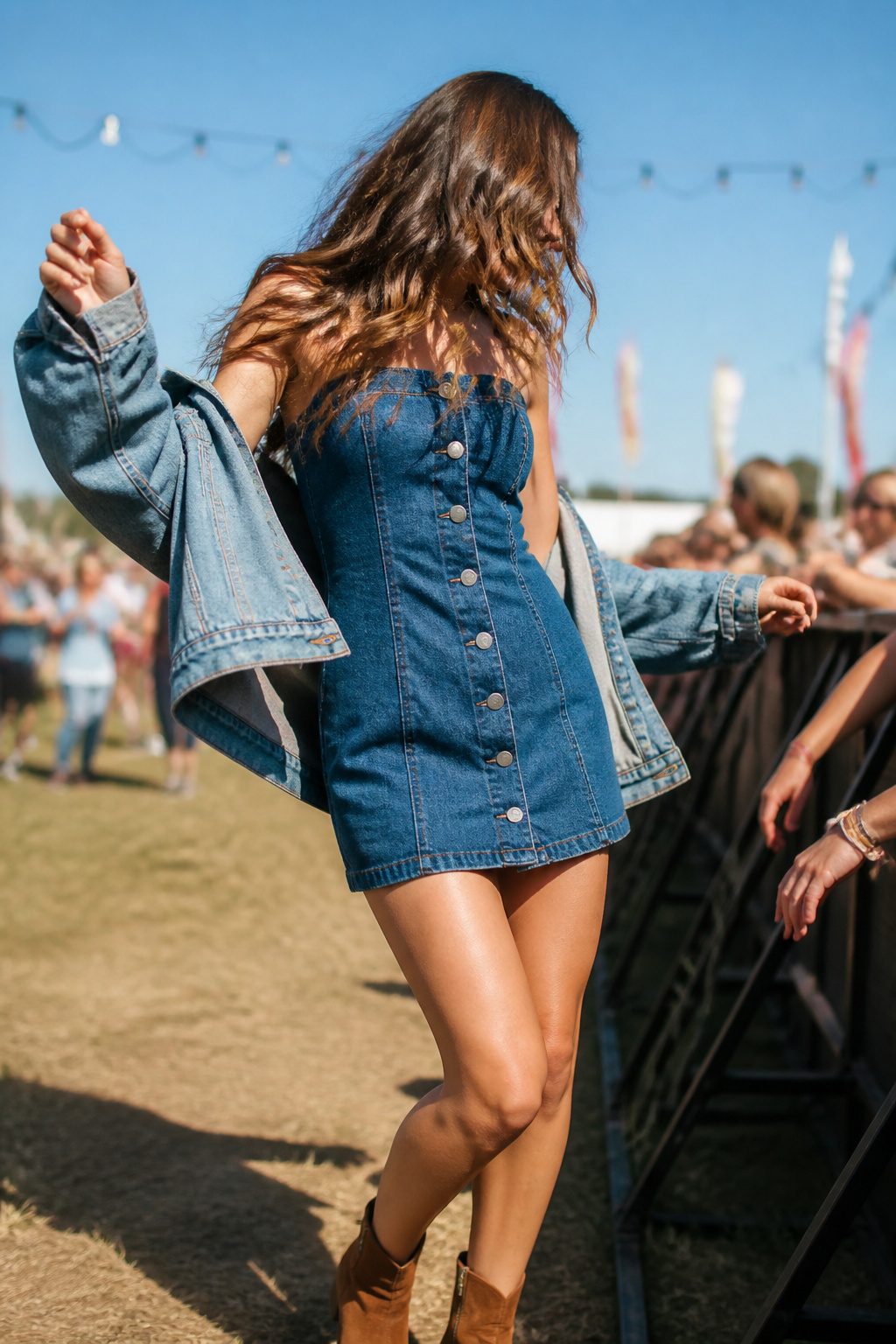 A denim button-front mini dress styled for a concert.