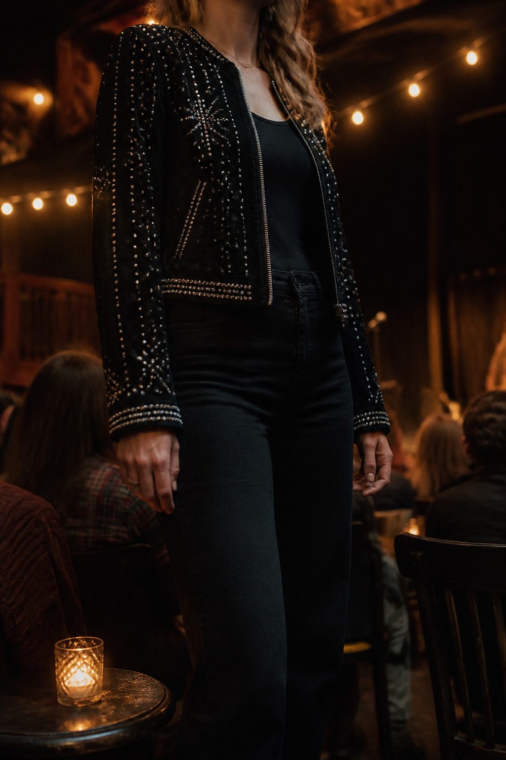 A close-up of a rhinestone-embellished jacket under stage lights.