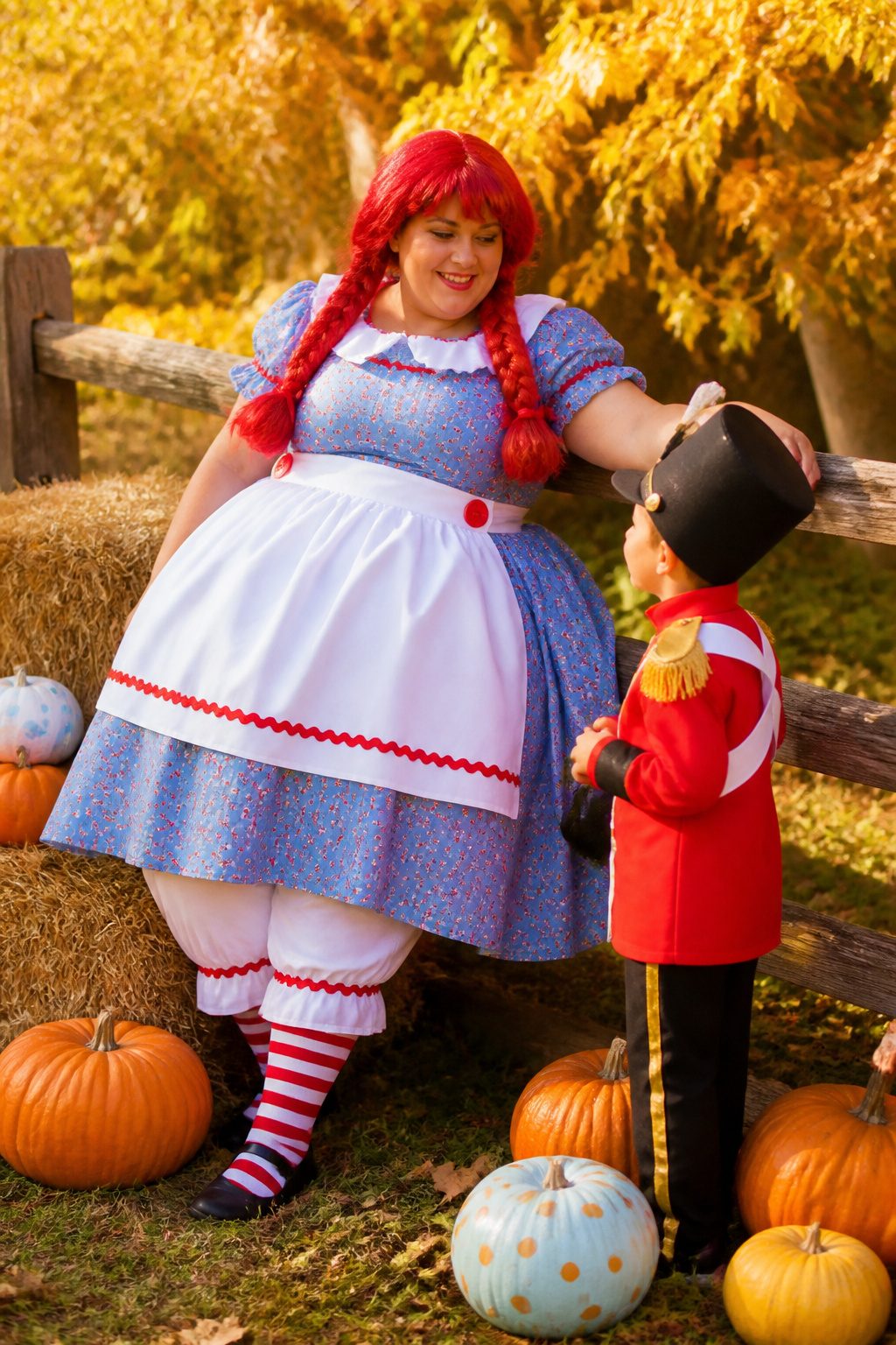 Plus-size model wearing a colorful Rag Doll costume in an autumn setting.