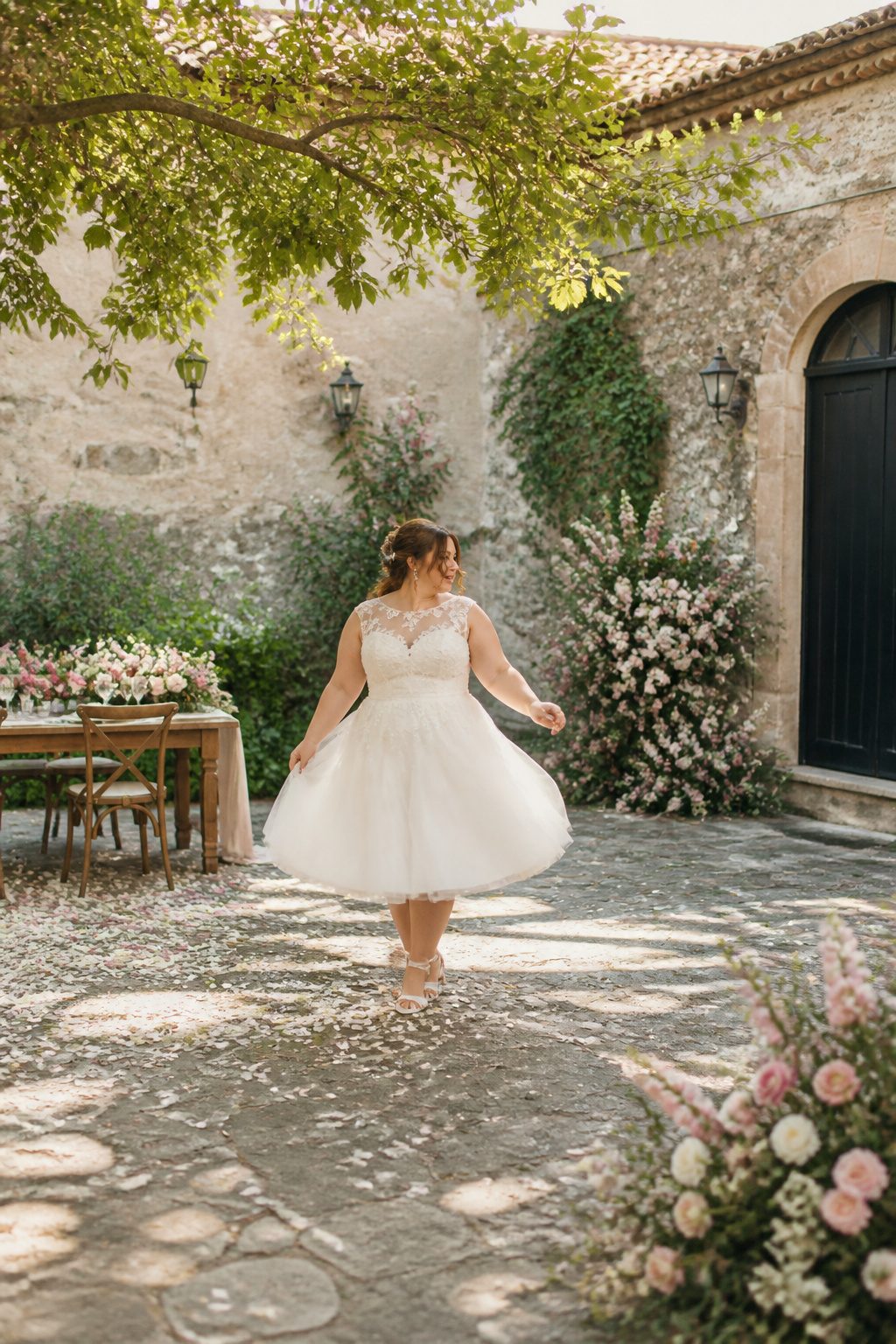 Plus Size Wedding Dress Styles: A-Line to Mermaid 5 A plus-size tea-length wedding dress with a defined waist and flared skirt.