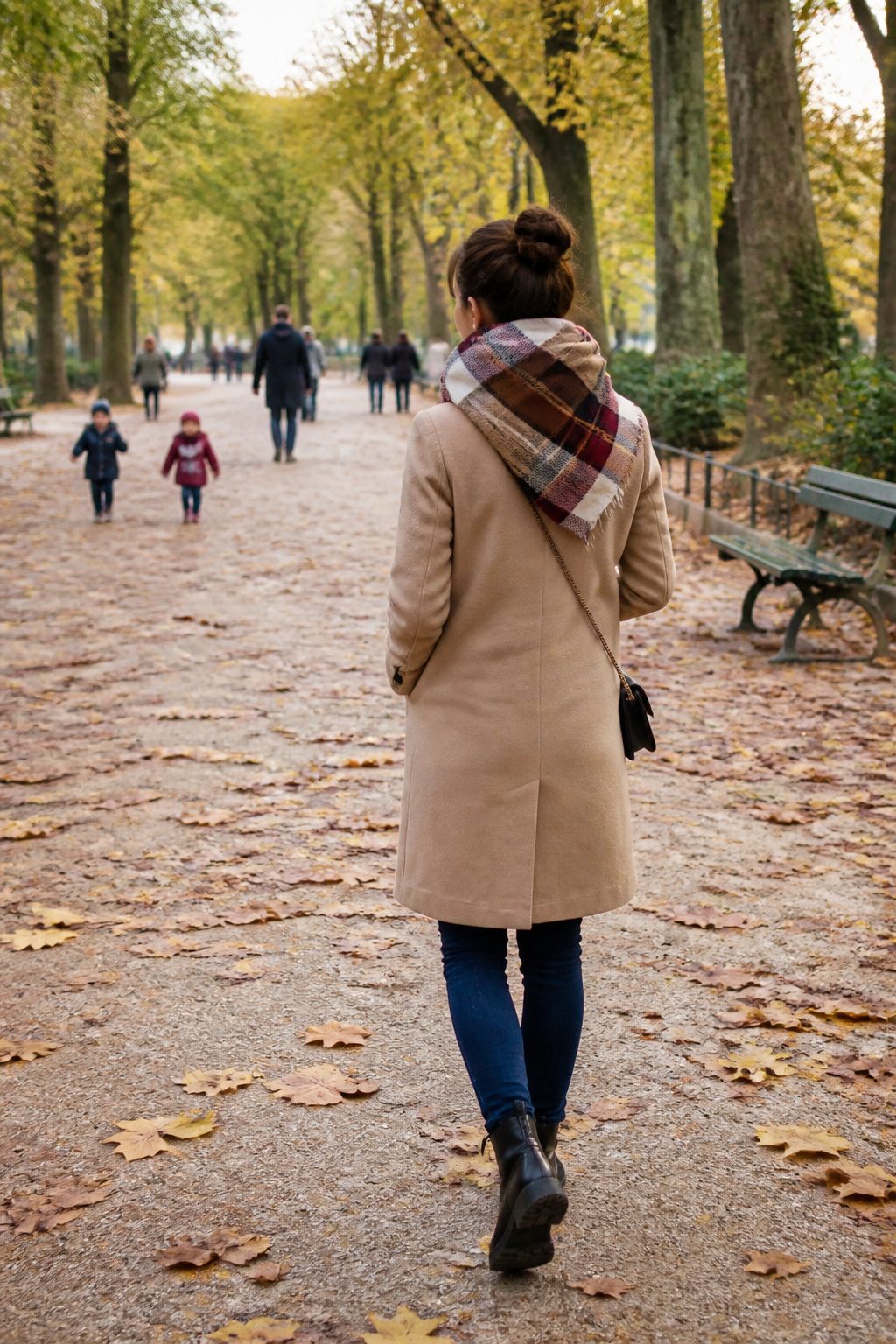 27 Winter Outfit Ideas for Women: 2026 Style Guide 15 Woman wearing a blanket scarf in an outdoor park.